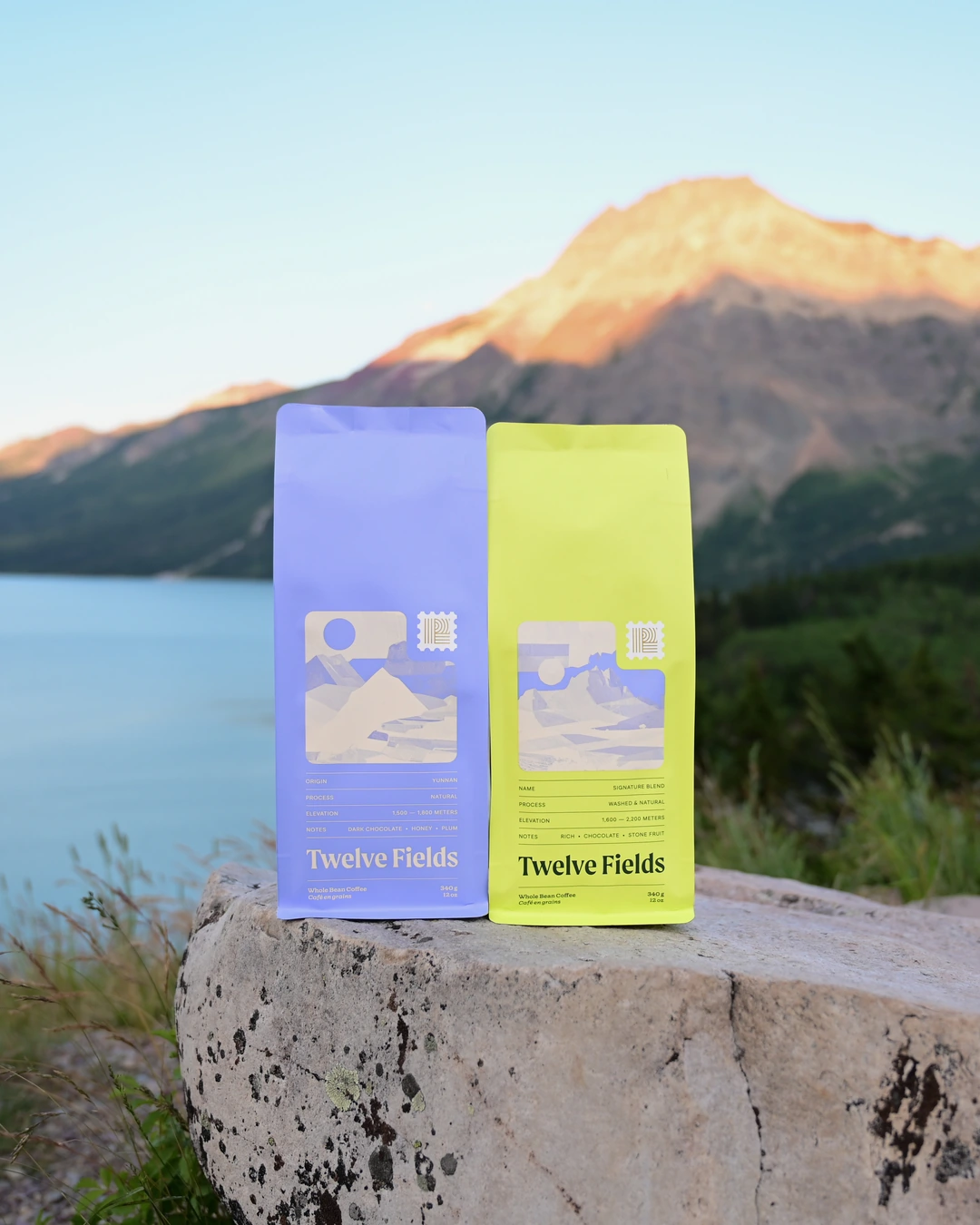 Two Twelve Fields coffee bags displayed in a Montana landscape