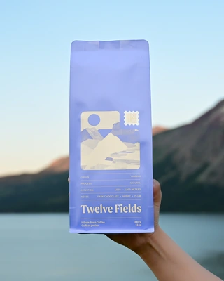 Yunnan Natural coffee held above a mountain lake