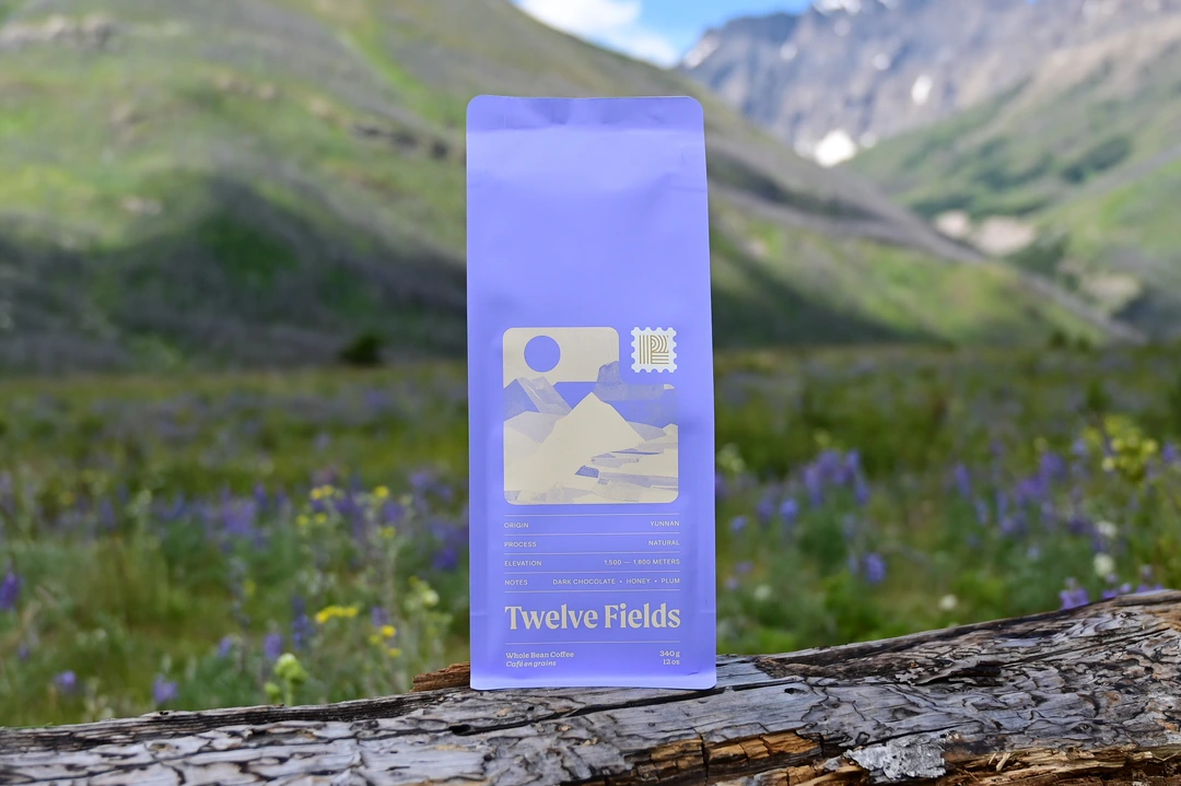 Yunnan coffee bag against the Teton mountain range in Montana